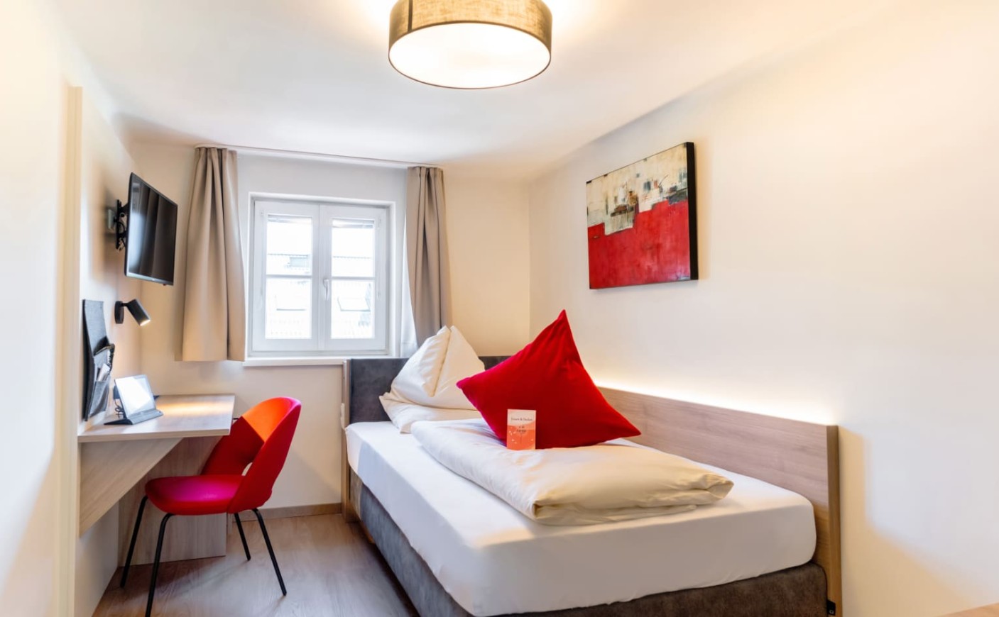 Einzelzimmer &ndash; komfortables Bett und viel Tageslicht in der Rosenvilla